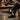 Breeze barefoot sneaker in black worn seated at a candlelit dinner