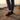Wave barefoot sneaker for men in black, worn at the beach at sunset, side view
