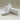 Wave barefoot sneaker in white, studio pair with one shoe flipped to show the sole