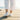 Wave barefoot sneaker in white, rear view worn walking on a wooden boardwalk by the sea