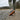 Wave barefoot sneaker for men in grey, worn on a gravel path showing the gum tread sole