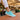 Wave barefoot sneaker in teal, single shoe side view worn at an outdoor flower market