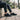 Terra barefoot trainer for men in black, worn seated on a park bench, side view
