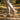 Pulse barefoot sneaker in sand beige with gum sole, worn mid stride on a forest path, side view