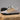Trailblazer barefoot hiking shoe for men in light grey with orange, studio pair on a rock, side view showing the wide toe box