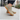 Summit barefoot hiking shoe in khaki taupe with orange sole, three quarter view worn on a sidewalk
