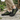 Trailblazer barefoot hiking shoe in black with lime green, worn as a pair on a stone path, three quarter view