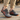 Cascade barefoot sneaker in grey with orange, worn on a wooden boardwalk, side view