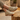 Anchor barefoot sneaker in cream worn seated, three quarter view of the laces