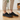 Anchor barefoot sneaker in black worn indoors, front view of both shoes