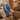 Stride barefoot sneaker for men in blue knit with brown sole, feet up on a wood stump