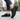 Terra barefoot trainer in black, worn on a city sidewalk, three quarter view showing the sole tread