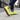 Stride barefoot sneaker for men in neon yellow knit with gum sole, worn walking a city street