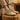 Pulse barefoot sneaker for men in sand tan with gum sole, worn with feet up on a wood stump indoors, three quarter view