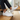 Meridian cushioned barefoot sneaker in white worn with feet up on wooden stairs