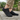 Meridian cushioned barefoot sneaker in black worn standing on stone, side view