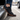 Sage barefoot sneaker in black tartan worn stepping out of a car