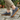 Ease barefoot slip on shoe in grey, worn side view walking on stone paving