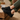 Breeze barefoot sneaker in black worn with feet up on a wooden crate
