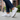 Wave barefoot sneaker for men in white, worn on a city sidewalk, side view