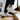Wave barefoot sneaker in white, worn on both feet stepping up wooden stairs