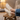Terra barefoot trainer for men in cream, worn with feet up on a wooden stool indoors, top down view