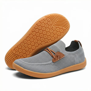 Loafers barefoot slip on shoe in grey knit, side view beside the gum sole
