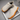 Ease barefoot slip on shoe in cream, top down view of the pair and toggle drawstring