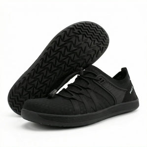 Wave barefoot sneaker in all black, pair with one shoe flipped to show the zigzag tread sole