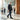 Breeze barefoot sneaker in black worn by a man in an office lobby