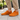 Ease barefoot slip-on shoe in orange, lifestyle view