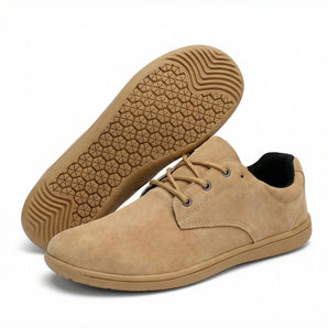 Haven barefoot lace up shoe in tan suede, side view beside the gum sole