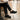 Wave barefoot sneaker for men in black, worn at a rainy street cafe, three quarter view