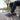 Wave barefoot sneaker for men in grey, rear view on a gravel path with gum sole