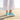 Wave barefoot sneaker in teal, rear view worn standing on a wooden boardwalk by the sea