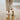 Terra barefoot trainer in cream, worn walking on a beach, rear view showing the sole tread