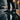 Terra barefoot trainer for men in black, worn on a wet cobblestone city street at dusk, side view
