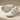 Cascade barefoot sneaker in white with pink, studio pair with one shoe showing the sole