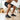 Cascade barefoot sneaker for men in black with grey, worn while doing a squat on a wood floor