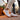 Pulse barefoot sneaker in white with gum sole, worn on a city rooftop terrace at dusk, side view