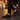 Flow barefoot slip on sneaker for men in black, worn on a wet cobblestone street at night, side view