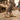 Grove barefoot sneaker for men in sand with gum sole, worn on a cobblestone market street