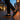 Grove barefoot sneaker for men in black with gum sole, worn on an evening city street