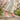 Grove barefoot sneaker in peach pink with white sole, worn walking a spring garden path