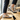 Trailblazer barefoot hiking shoe in light grey with orange, worn as a pair on a wooden step, three quarter view