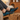 Cascade barefoot sneaker for men in black with teal blue, worn with feet up on a wooden stump indoors