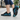 Cascade barefoot sneaker in black with teal blue, worn while walking on a city sidewalk