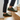 Anchor barefoot sneaker in olive green worn on stairs, three quarter view for men