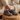 Anchor barefoot sneaker in charcoal grey worn seated, close up of the toggle lace