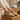 Haven barefoot lace up shoe in tan worn with feet up on a wooden block
